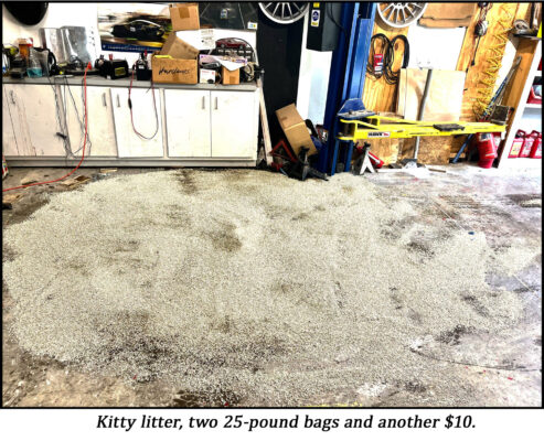 kitty litter poured over spilled motor oil